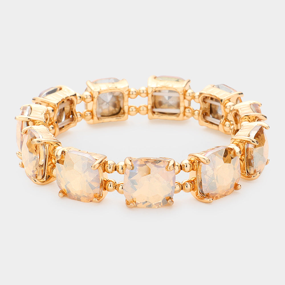 Light topaz gold stone cushion square stone stretch evening bracelet on gold, elegant statement bracelet for evening and special occasions on a white background