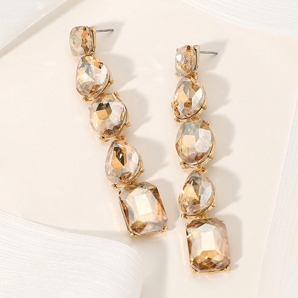 Light topaz gold stone faceted stone cluster prom pageant evening earrings in a gold setting on an off white background