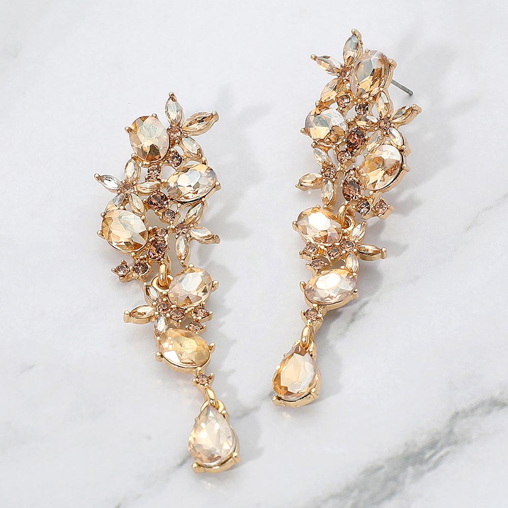 Light topaz gold stone floral crystal drop earrings with marquise stones on gold backing for interviews or evening elegance on a marble background