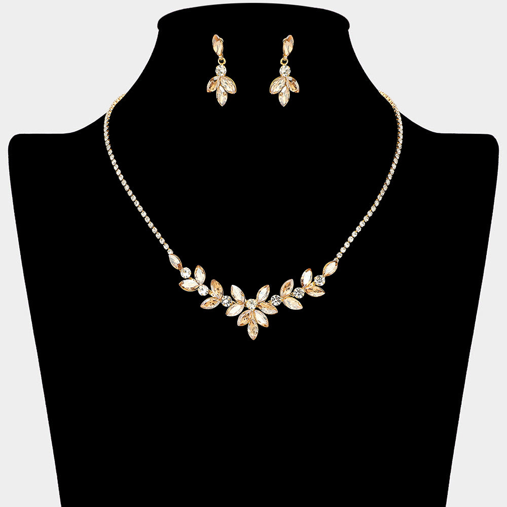 Gold stone crystal marquise leaf necklace and earring set on gold for formal events and pageants on a black mannequin bust on a white background.