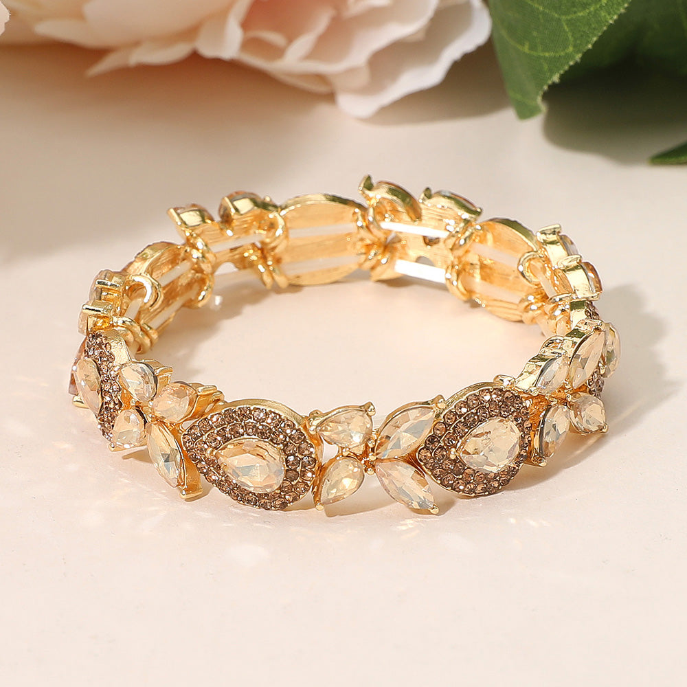 Light topaz rhinestone marquise bracelet on gold for autumn weddings or pageants on a peach background