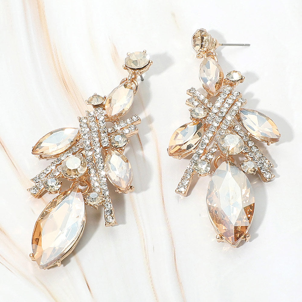 Gold stone light topaz marquise stone and rhinestone cluster drop earrings on gold on white marble background