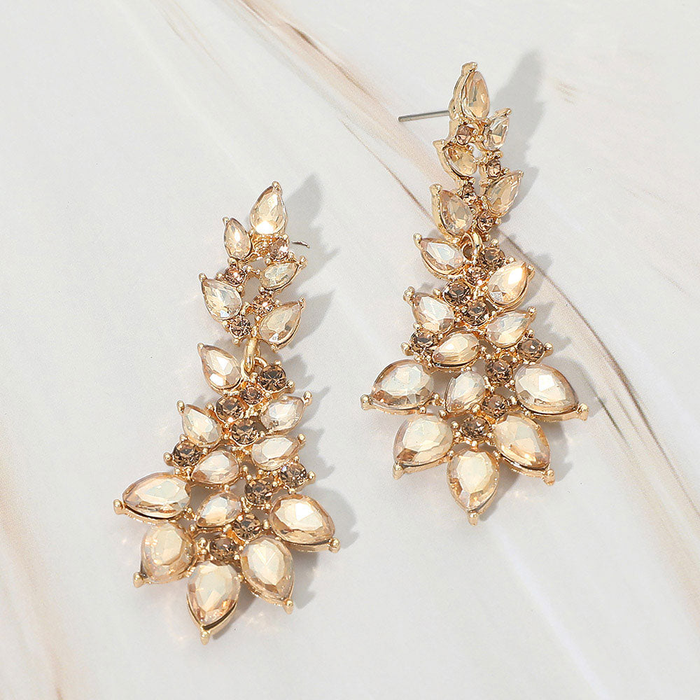 Gold stone light topaz teardrop cluster drop earrings on gold with faceted stones on white marble background