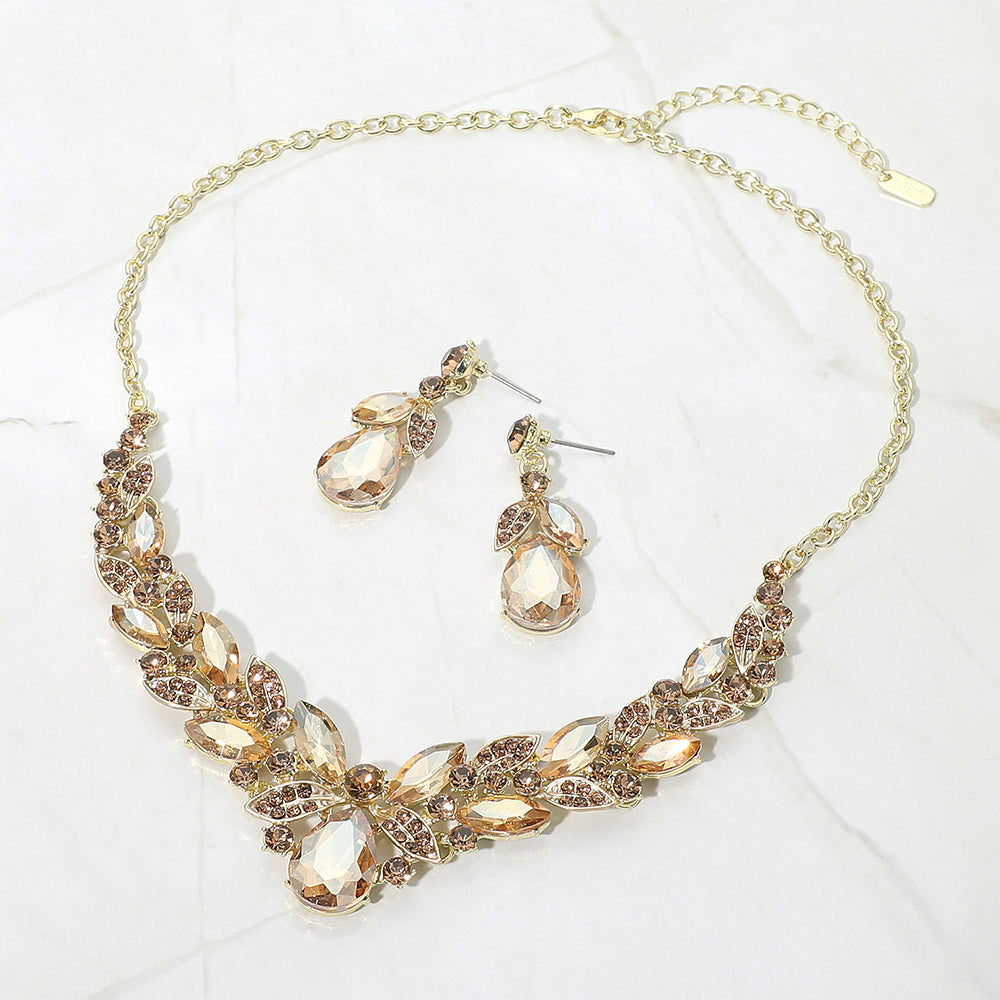 Light Topaz Gold Stone teardrop and marquise crystal jewelry set on gold displayed on white marble background