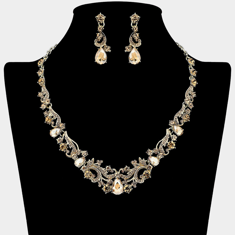 Light topaz-gold stone teardrop rhinestone cluster necklace set on gold with matching earrings for prom and formal wear. Shown here on a black mannequin bust.

