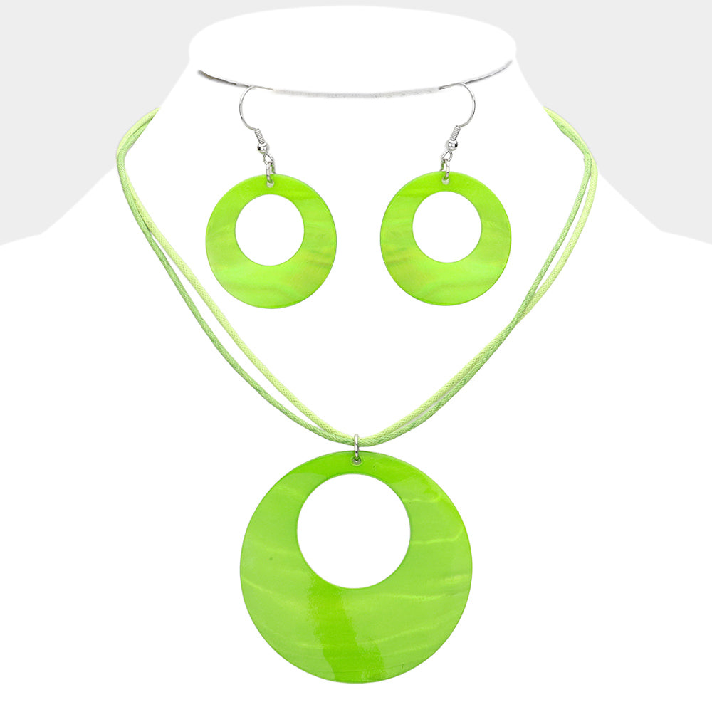 Lime Green open-circle necklace set on silver with an oversized round pendant and matching open-circle earrings, displayed on a white jewelry bust.