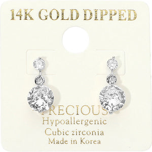 Little Girls' clear crystal round drop earrings on silver featuring a smaller round crystal suspended above a larger round crystal, displayed on a off white jewelry card.