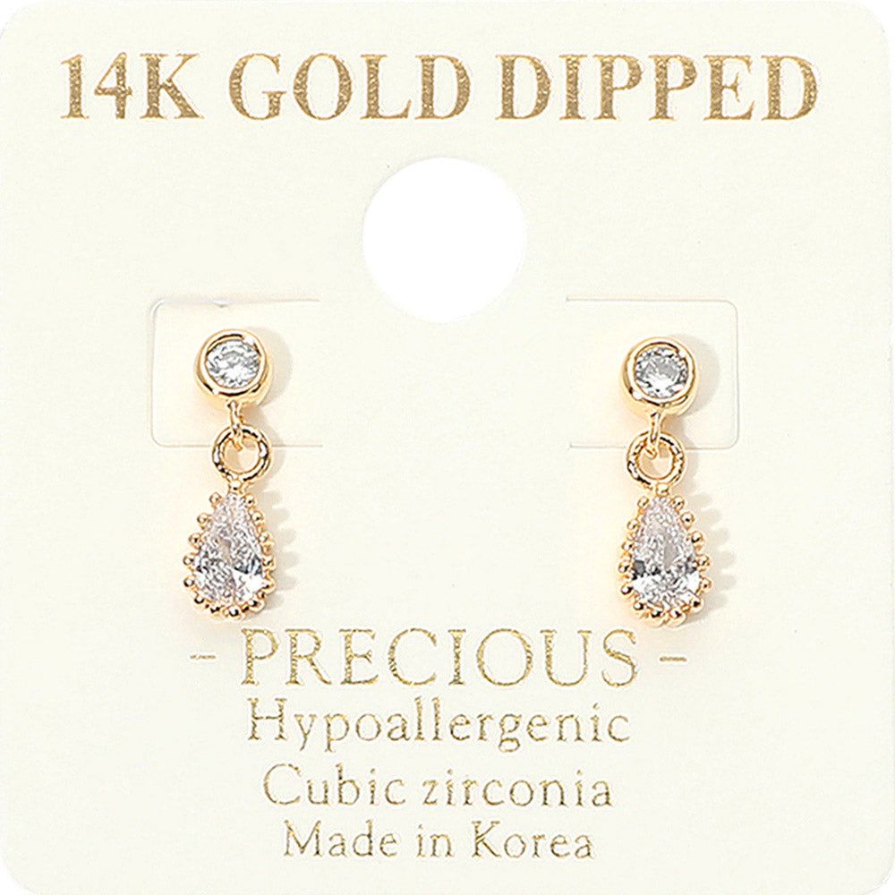 A pair of gold dangle earrings backed in gold with clear teardrop-shaped cubic zirconia stones, displayed on a cream-colored jewelry card that reads '14K GOLD DIPPED' and 'PRECIOUS Hypoallergenic Cubic zirconia Made in Korea'.