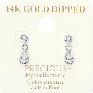 A pair of 14K gold-dipped cubic zirconia dangle earrings on a cream-colored display card. The earrings feature a silver-tone setting with a round clear stone and a teardrop-shaped clear stone below, presented on a card with gold text detailing.