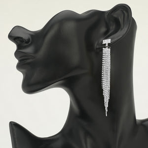 Long clear rhinestone tassel fringe earrings on silver displayed on black mannequin bust