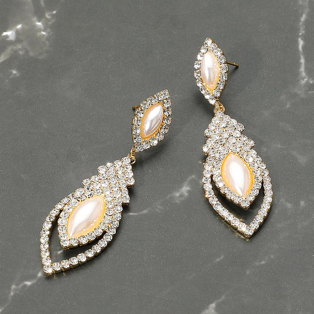 Marquise cream pearl and clear crystal dangle earrings on gold — elegant cascading bridal and evening jewelry perfect for weddings or prom. Shown here on a grey marble background.