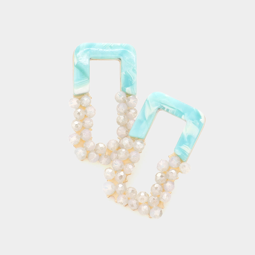 A pair of mint beaded open rectangle earrings with pearl-like bead accents, displayed on a light background.