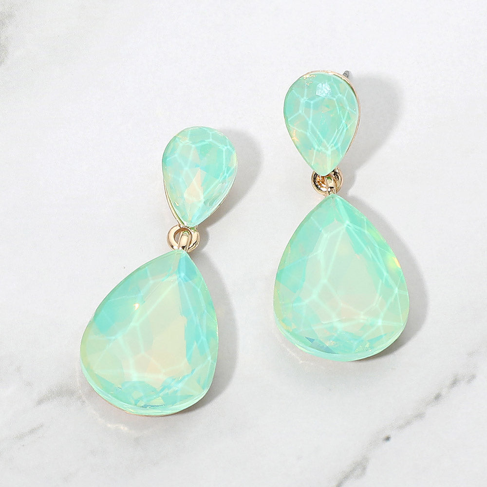Mint opal crystal double teardrop dangle earrings on gold displayed on a white marble background.