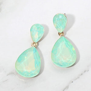 Mint opal crystal double teardrop dangle earrings on gold displayed on a white marble background.