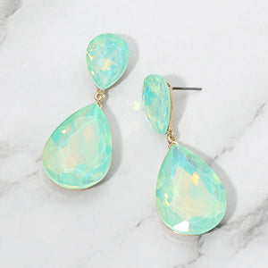 Mint opal crystal double teardrop dangle earrings on gold displayed on a white marble background.