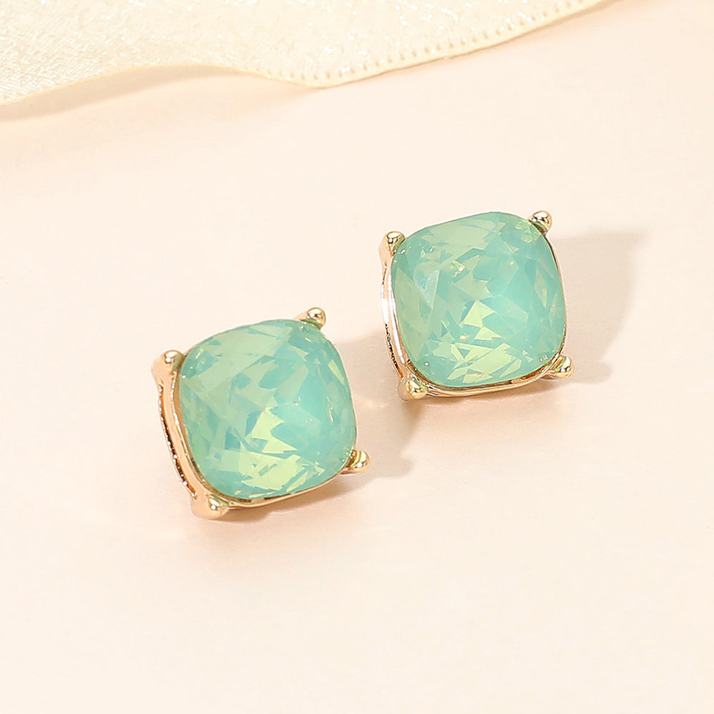 Mint opal square cushion stud earrings on gold on light beige background