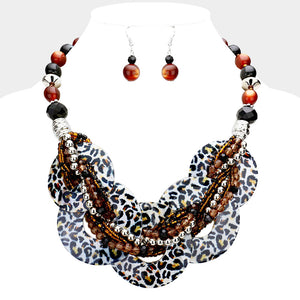 White animal print chunky round link statement necklace set with matching earrings on white bust