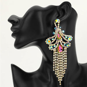 A large ornate Multi-Color crystal statement earring on gold with cascading bead fringe and colorful crystal accents on a black earring mannequin.