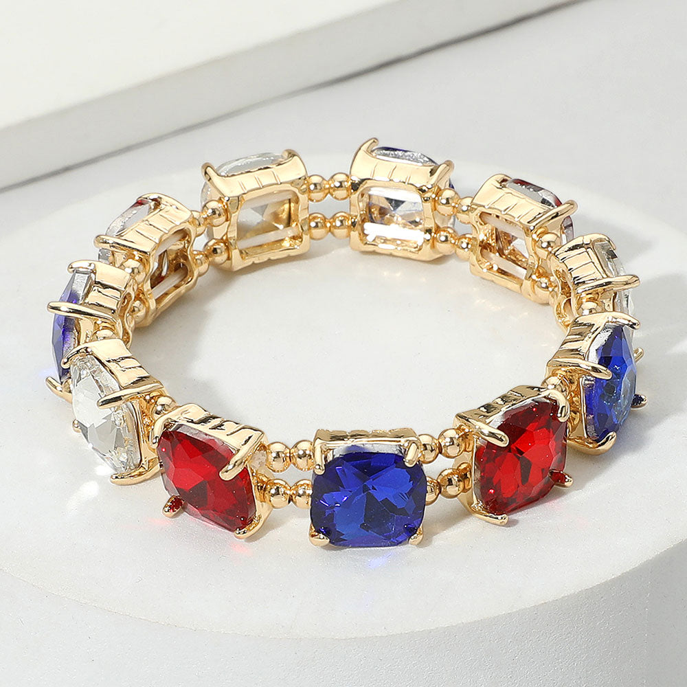 Multi-color cushion square stone stretch evening bracelet on gold, colorful statement bracelet on a white background