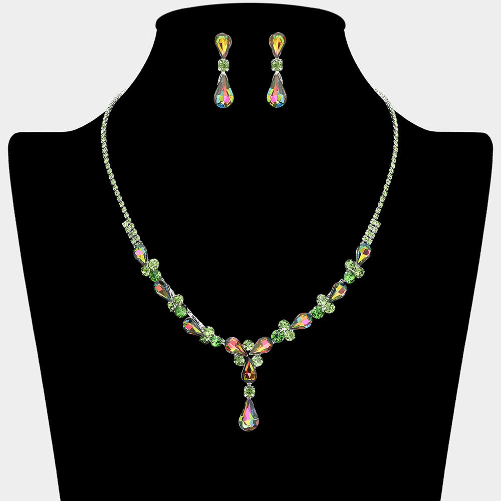 Multi-color teardrop crystal necklace set on silver with matching earrings for prom and evening wear on a black mannequin bust on a white background.