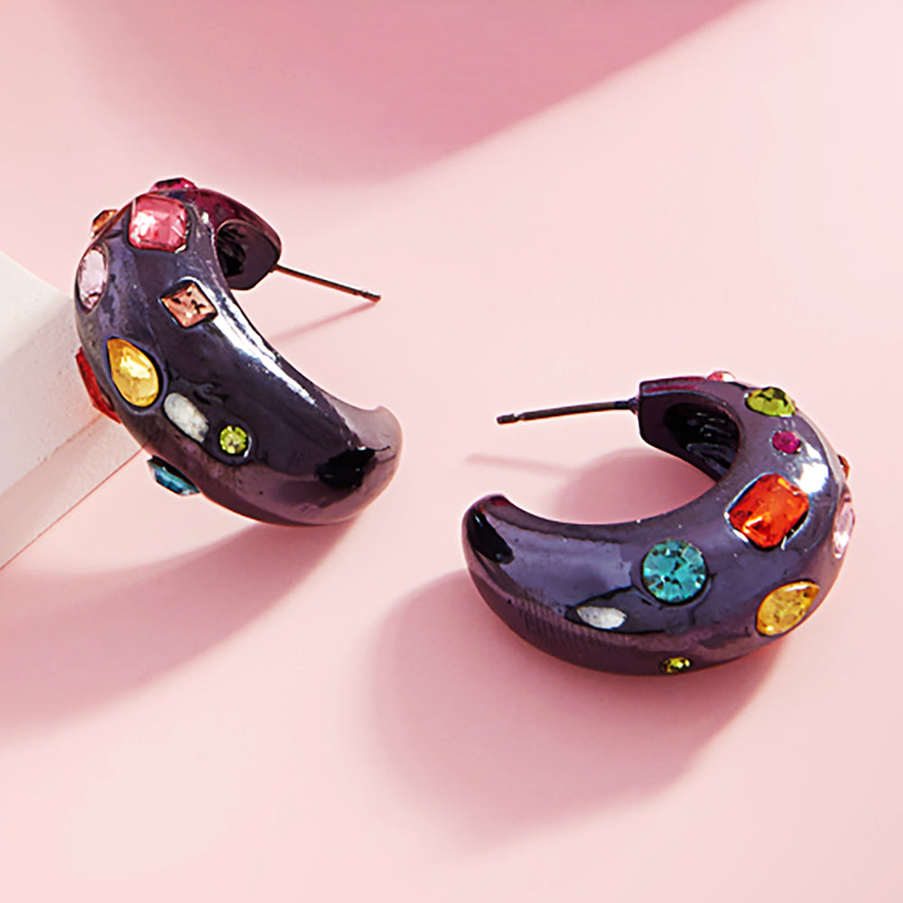 Multi color stone chunky half hoop earrings on black with vibrant mixed crystals, 1.25 inch earrings on a pink background