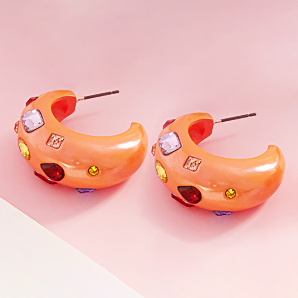 Multi color stone chunky half hoop earrings on orange with vibrant mixed crystals, 1.25 inch earrings on a pink background