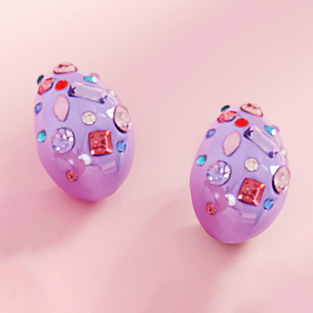 Multi color stone teardrop earrings on lavender with vibrant mixed crystals, 1.25 inch drop earrings on a pink background
