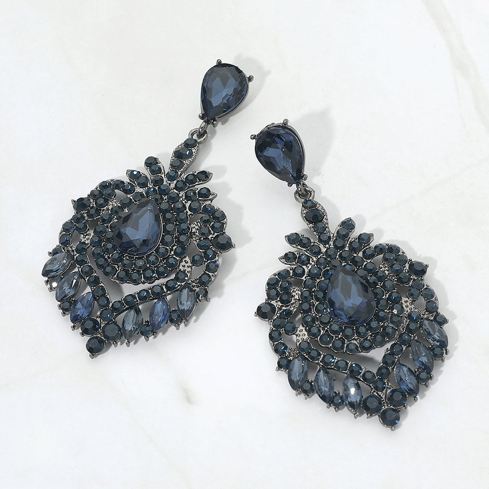Navy crystal teardrop chandelier statement pageant earrings on gun metal with an ornate layered crystal design, displayed on a white background.