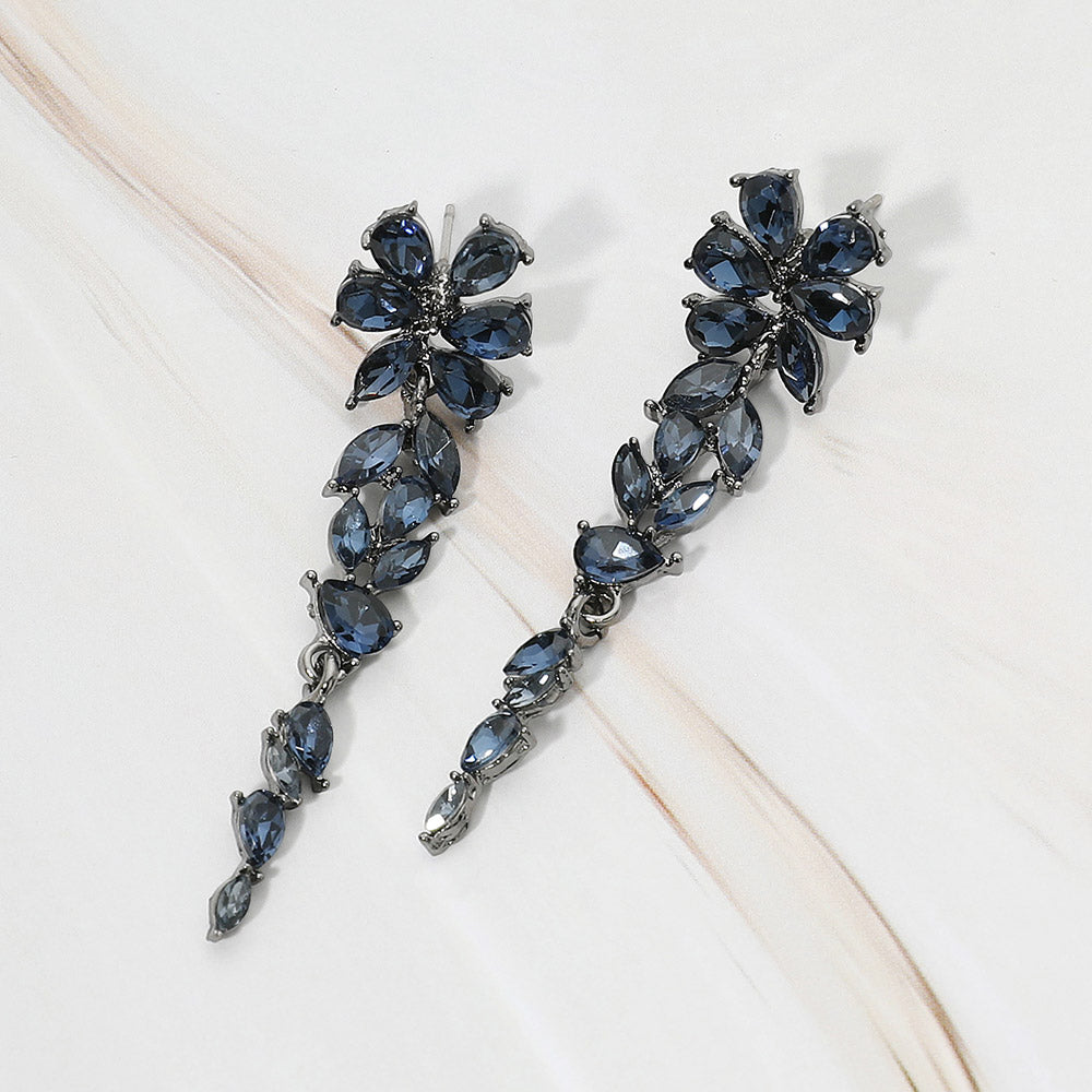 Gunmetal-tone dangle earrings featuring navy marquise and round faceted crystals arranged in an elongated floral vine design, displayed on a white background.