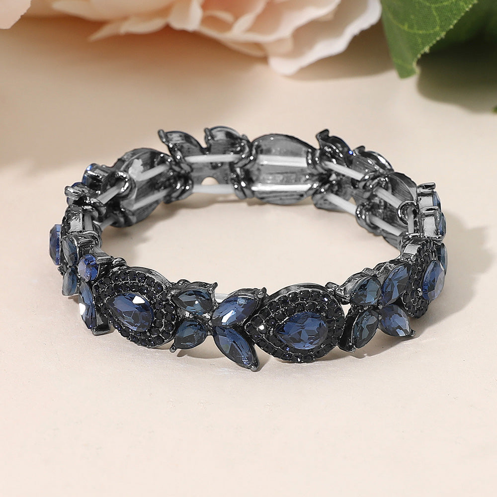 Navy marquise rhinestone stretch bracelet on silver for pageants and evening wear on a peach background