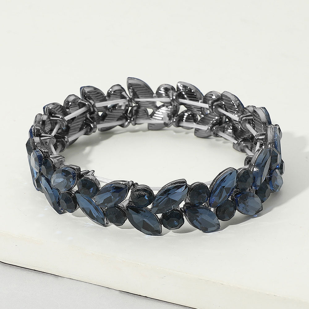 Navy blue royal blue marquise and round stone cluster stretch bracelet on black on a white marble background