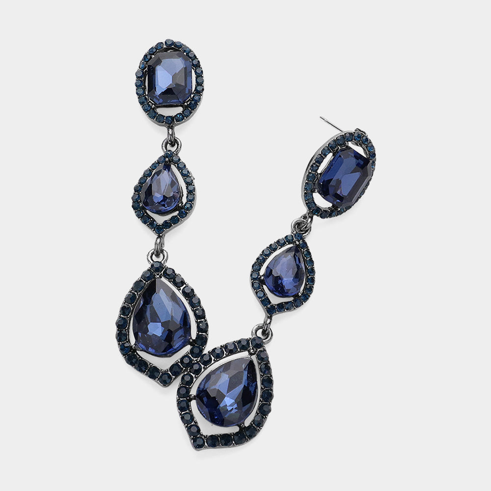 Pair of gunmetal-tone drop earrings featuring large navy oval and pear-shaped crystals surrounded by small clear stones on a light gray background.