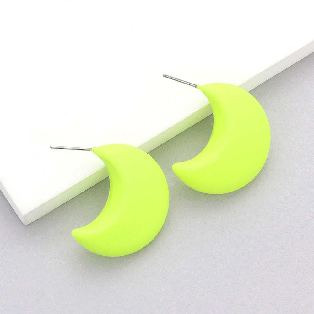 Neon yellow matte crescent moon earrings on a white background