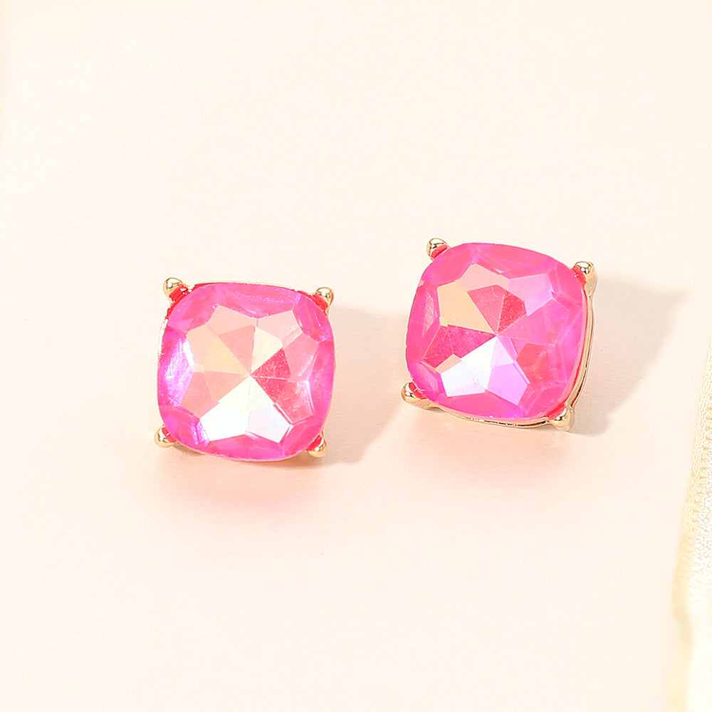 Neon pink square cushion stud earrings on gold on light beige background
