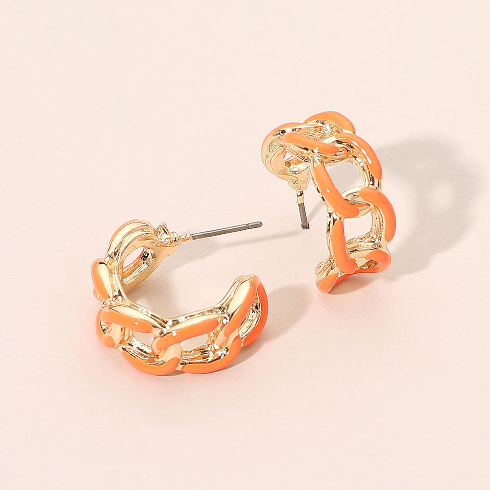 Orange enamel chain hoop earrings with mini linked half-hoop design and post-back closure on a beige background