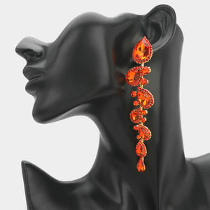 Orange long teardrop stone cluster drop evening earrings on gold on a black mannequin ear