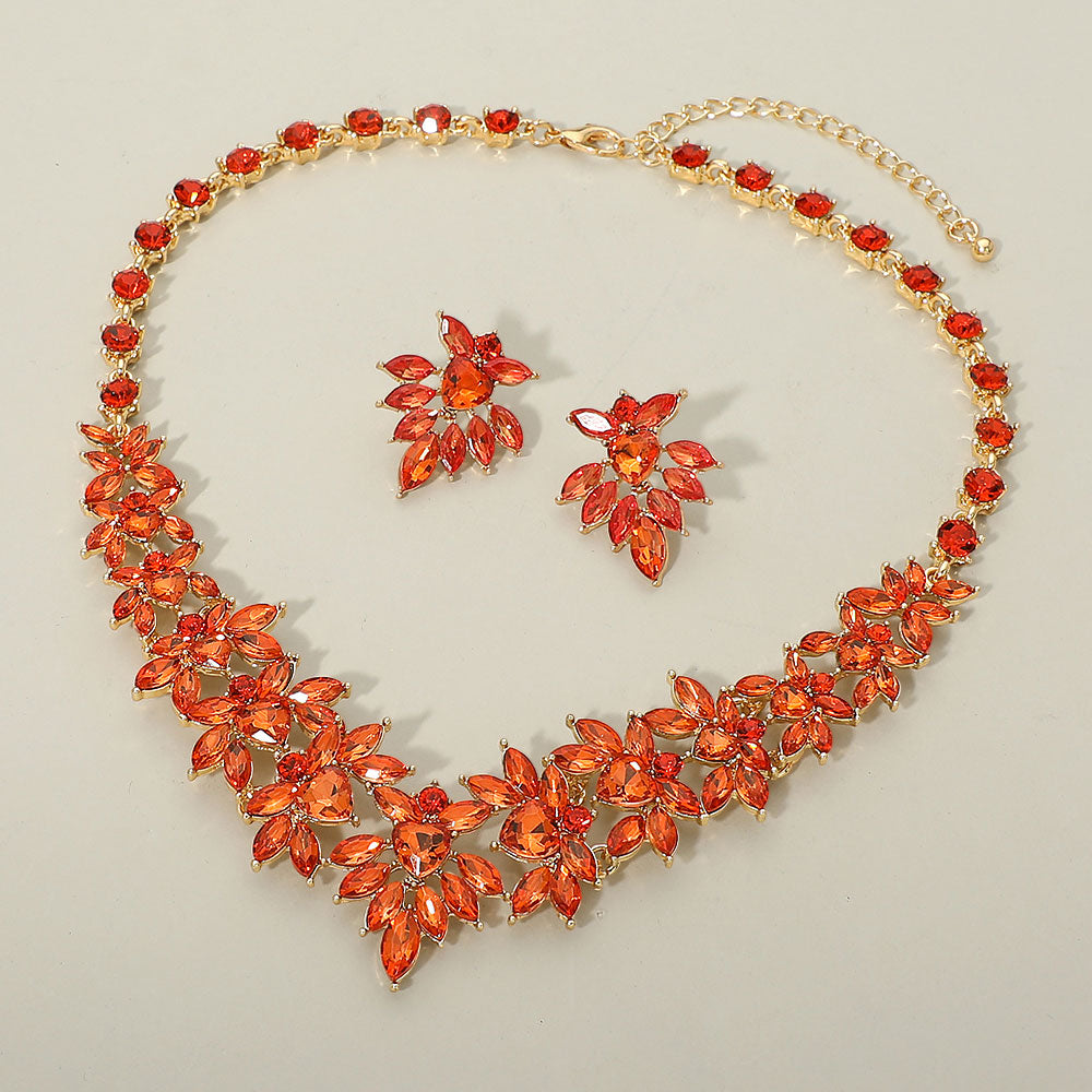 Orange marquise floral statement necklace set on gold on a beige background