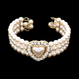 Cream Pearl bridal bracelet with a cream pearl heart of pearl in the center on a black background