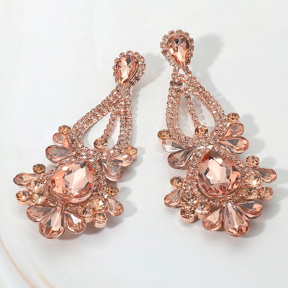Peach chandelier teardrop statement earrings on rose gold for prom or bridal events on a white background