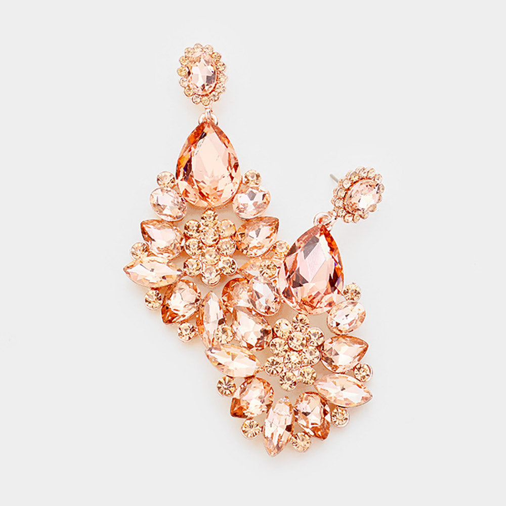 Floral teardrop earrings with peach crystals on rose gold, featuring oval crystal tops, large teardrops, and flower clusters with petal-shaped stones, displayed on white marble.