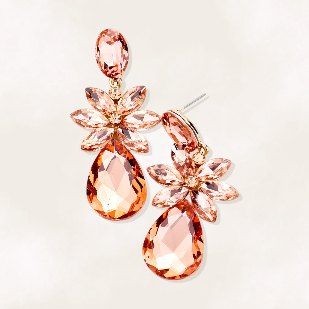Peach crystal flower teardrop earrings on gold displayed on white background