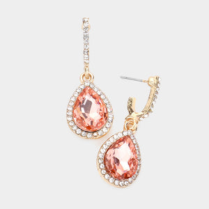 Peach teardrop rhinestone trim dangle earrings on gold on white background