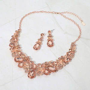 Peach teardrop floral statement necklace set on rose gold displayed on white background