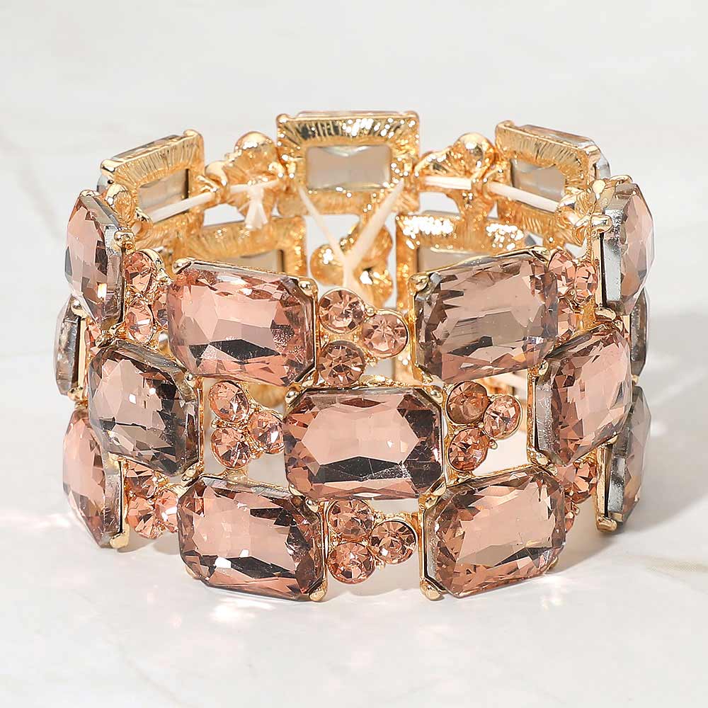 Peach wide emerald cut crystal stretch bracelet on gold on white background