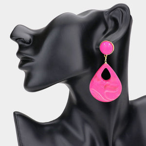 Bubble Gum pink resin teardrop cutout dangle earrings on a black mannequin ear on a white background— bold modern 3.25" fashion statement jewelry.