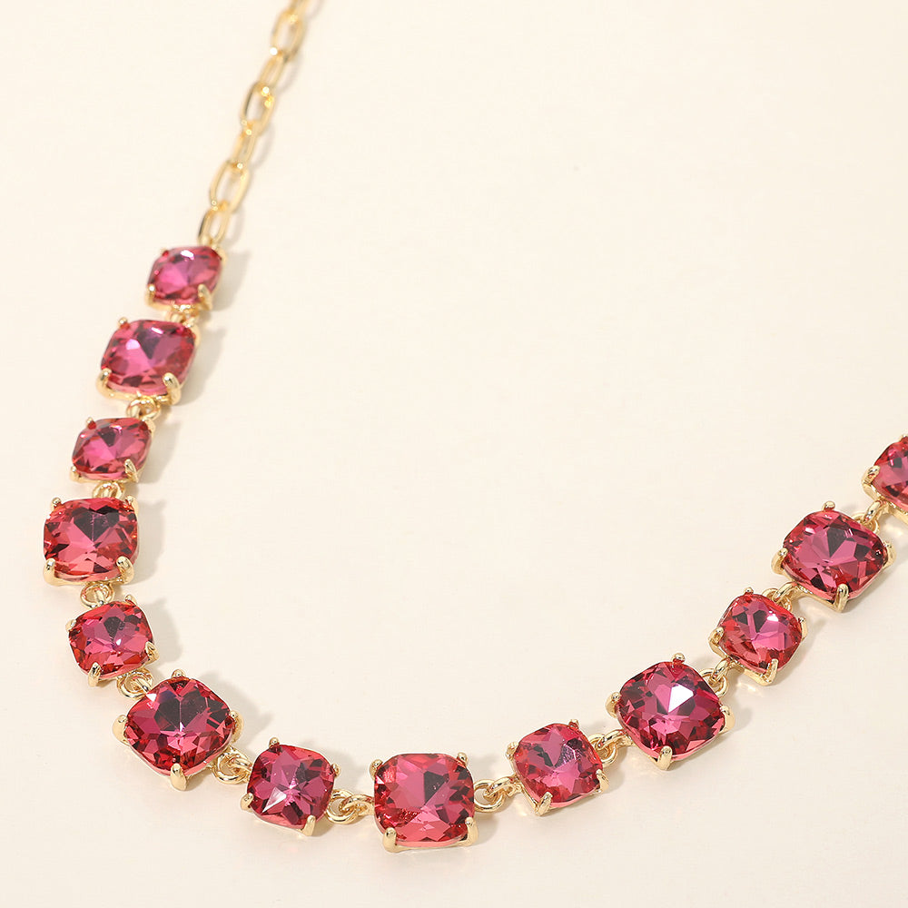 Pink AB cushion cut crystal link necklace on gold displayed on beige background