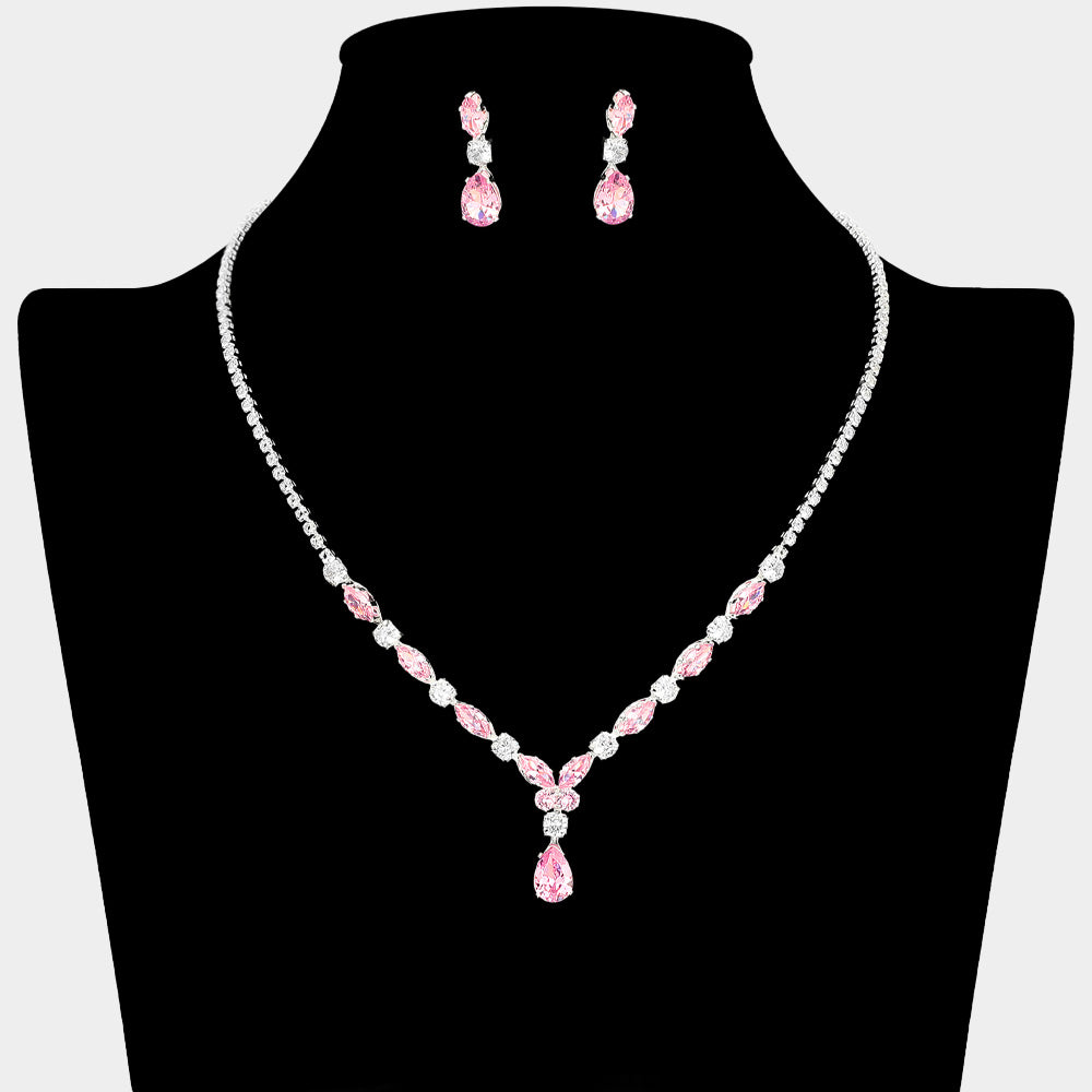 Pink and clear crystal dainty necklace set on silver with spaced crystal accents, a delicate center drop, and matching drop earrings, displayed on a black jewelry bust.