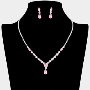 Pink and clear crystal dainty necklace set on silver with spaced crystal accents, a delicate center drop, and matching drop earrings, displayed on a black jewelry bust.