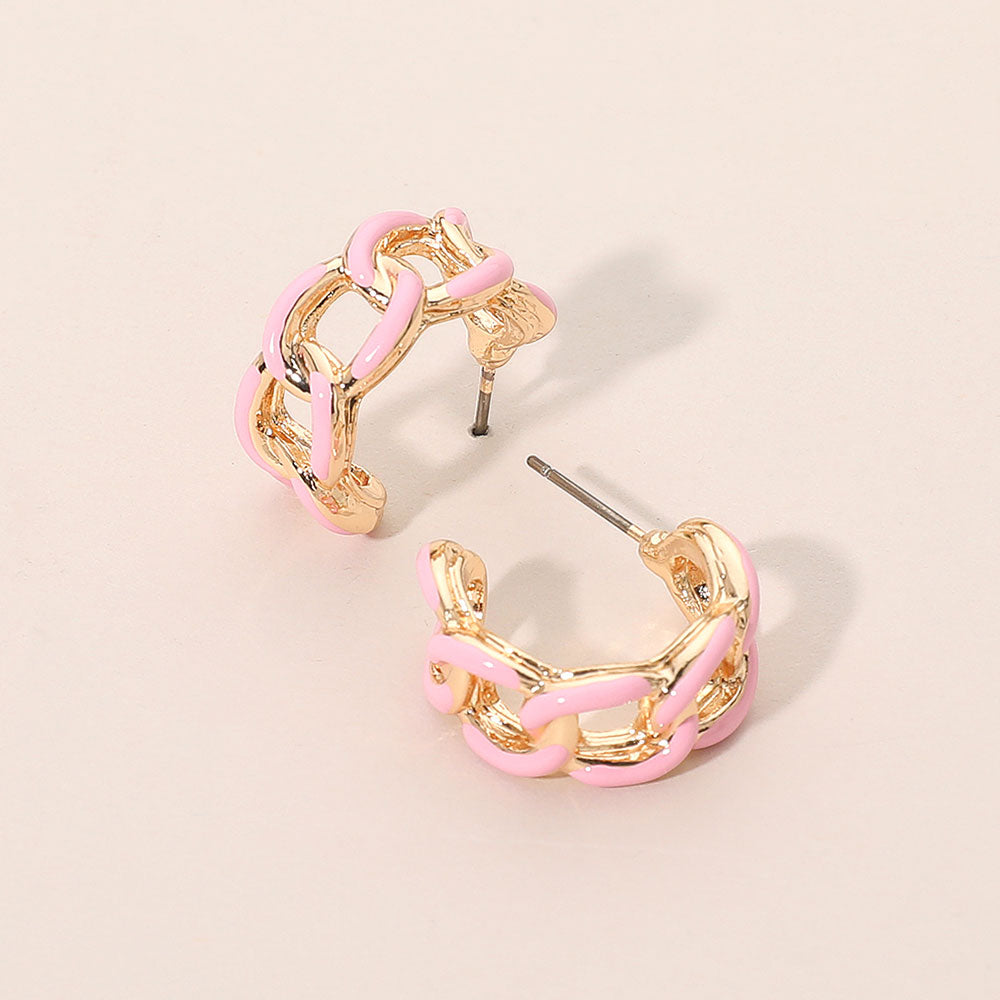 Pink enamel chain hoop earrings with mini linked half-hoop design and post-back closure on a beige background