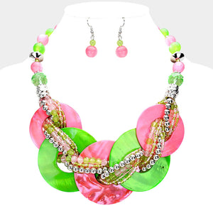 Pink and green chunky round link statement necklace set with matching earrings on white bust